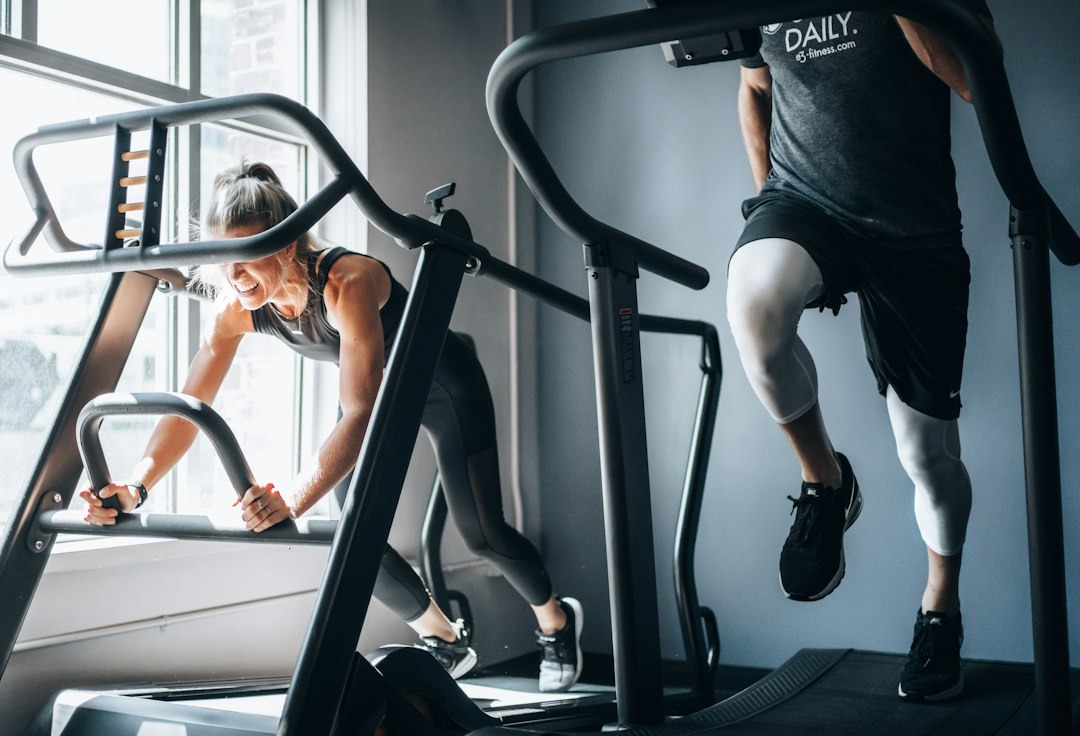 Woman intensely exercising on treadmill in a gym.